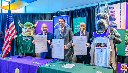 HVCC President Roger Ramsammy, SUNY Chancellor John King,University at Albany President Havidán Rodríguez pose with Damien the Great Dane and Victor the Viking mascots